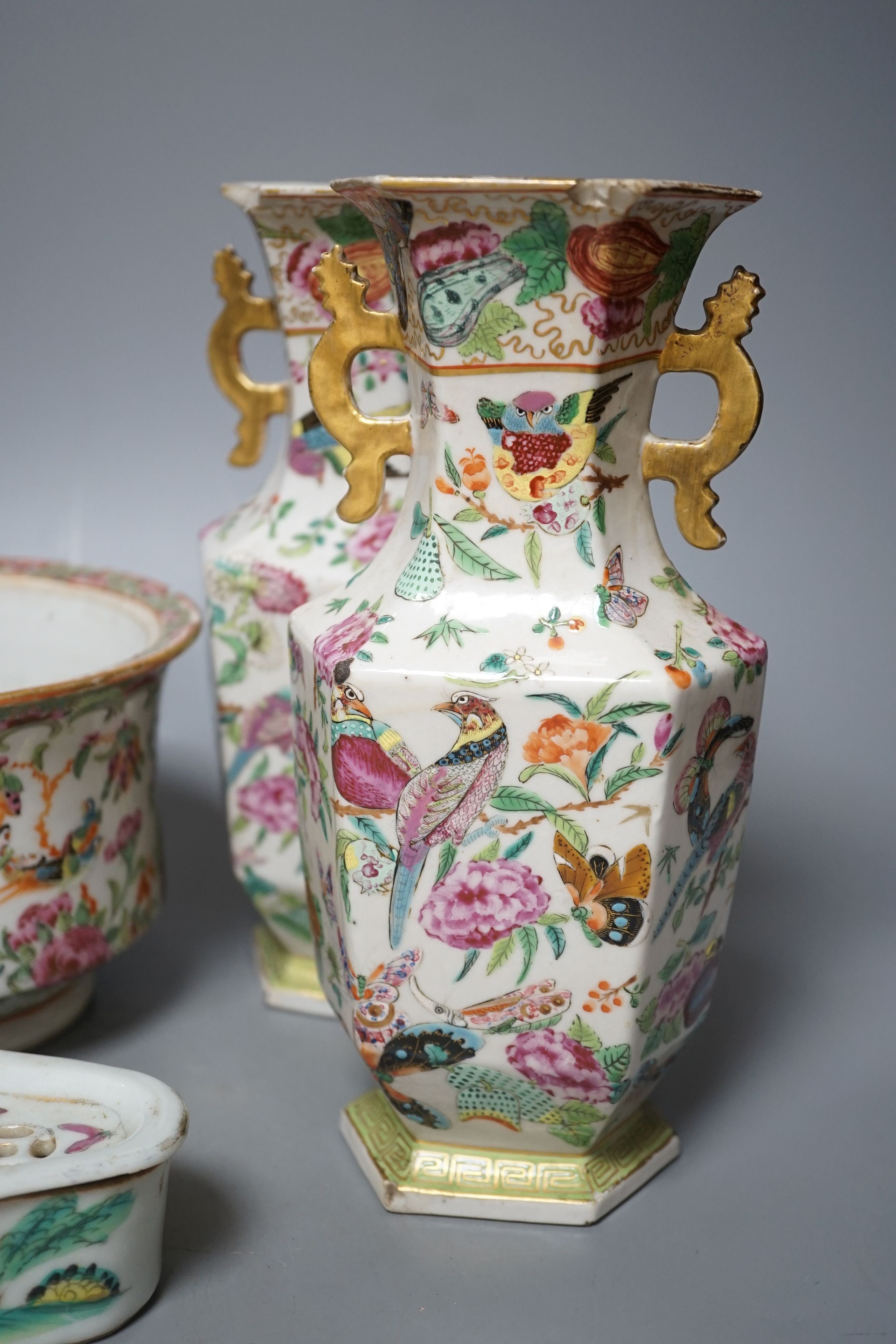 A group of 19th-century Chinese enamelled porcelain vessels, to include a jar, a pair of hexagonal vases, a pot and a cricket cage, Pair of vases 22cm high.